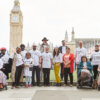 Members of the back the one in six hand-in delegation stand together. Big Ben is in the background.